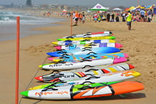 Surf boards on beach with competition in background